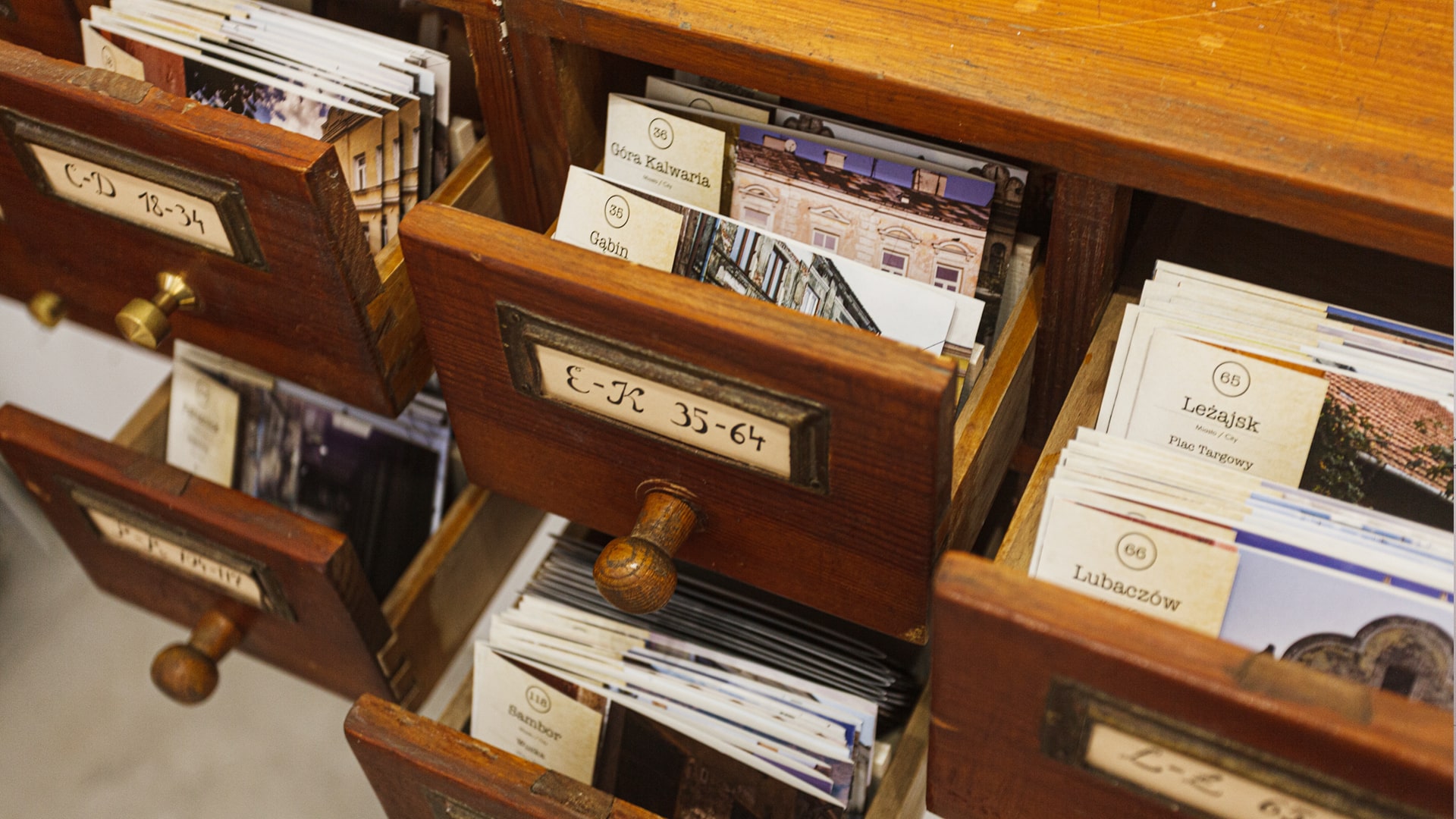 Wooden archive drawers filled with catalogued cards about mezuzah traces and historic locations