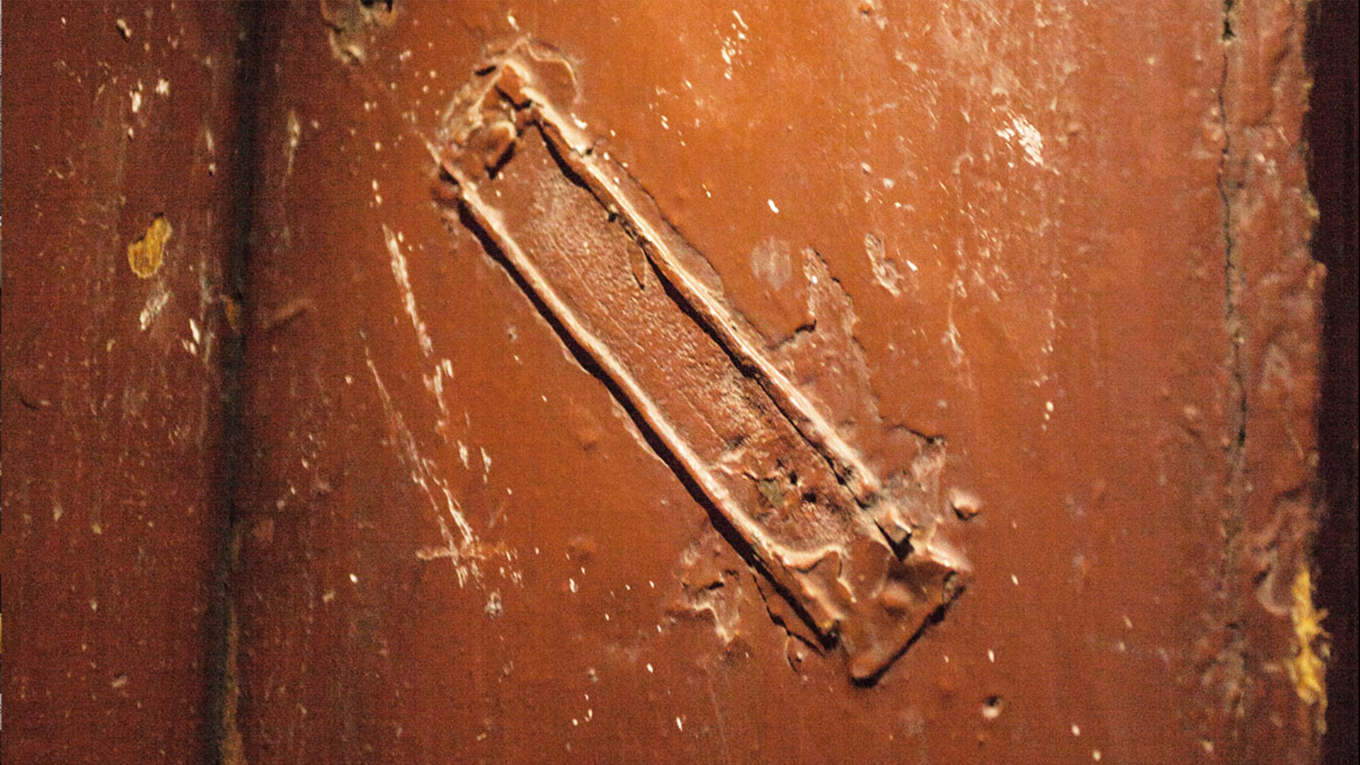 Close-up of an old doorpost showing a weathered mezuzah trace, symbolizing memory and connection to past generations, designed by MI POLIN design