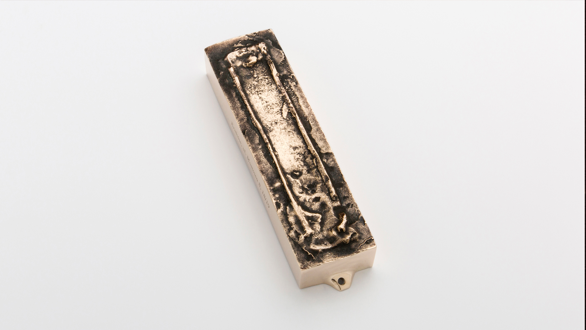 Bronze mezuzah case cast from an actual mezuzah trace, honoring the memory and history of its original home, designed by MI POLIN design
